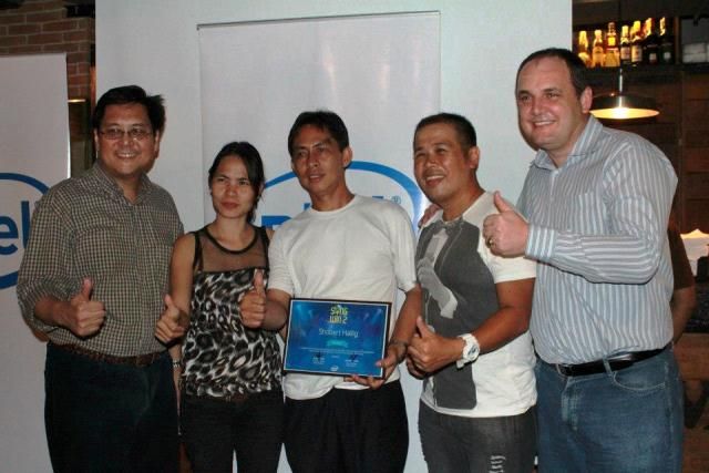 Intel Philippines executives flank representatives of the Intel Sing to Win 2 grand winner Shobert Hallig.-1